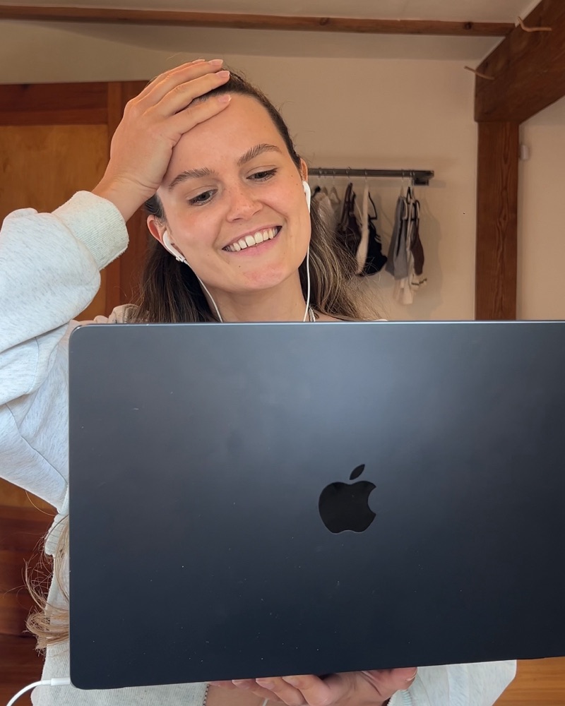 Yule smiling at her laptop
